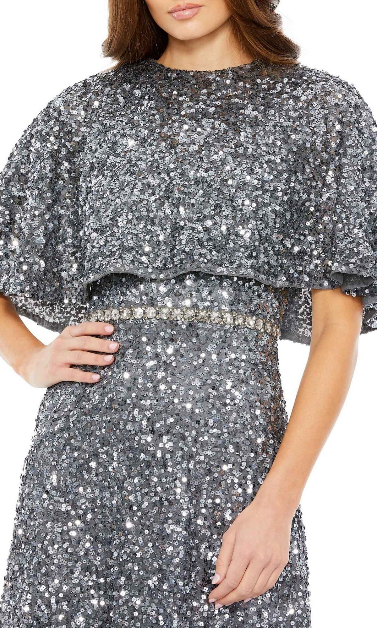 A woman wearing the Mac Duggal 5577 Caped Midi Semi-Formal Dress in silver sequins, featuring short, wide cape sleeves and a fitted waist, shown from shoulders to mid-thigh.